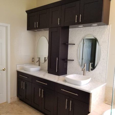 Bathroom with two sinks and many different cabinets